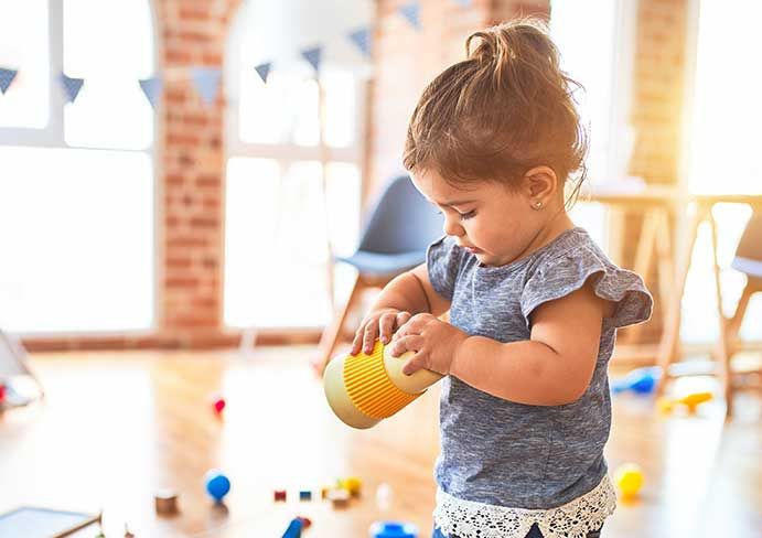 the girl holds a cup in her hand