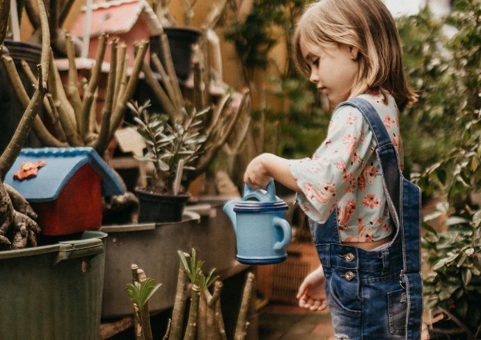  the girl stands in the garden with a convection oven